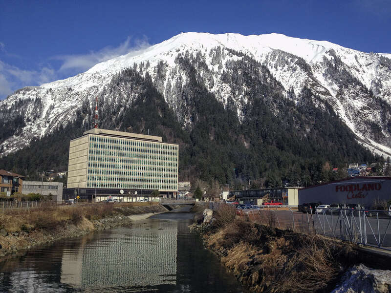 Juneau Federal Building with reflection in Gold Creek, and Mount Roberts - Southeast Alaska by Gillfoto