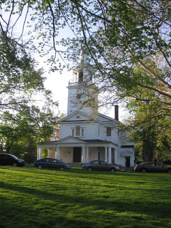 The First Congregational Church on the hill in Washington, Connecticut, USA.  View looking north-northwest.  The church back lies along Green Hill Road (CT Route 47), but the front of the church faces the green.