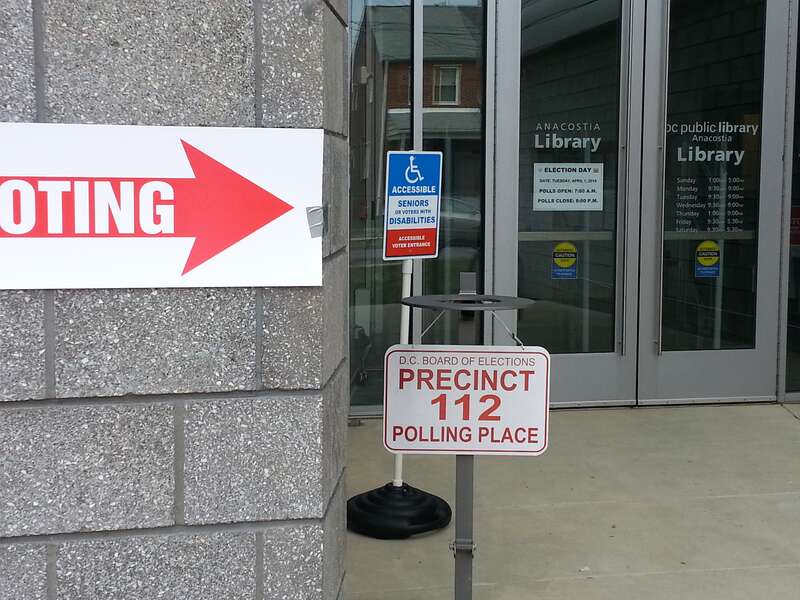 U Place SE entrance to the Anacostia Branch of the D.C. Public Library on primary election day, April 1, 2014.  Big red &quot;VOTING&quot; signs are everywhere.  Note the &quot;Precinct 112 Polling Place&quot; sign, the advice to disabled people or seniors, and the