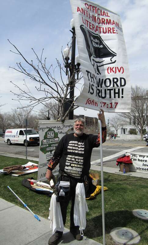 A Christian protester on the street of Temple Square, presenting the King James Version of the Bible as "official anti-Mormon literature".