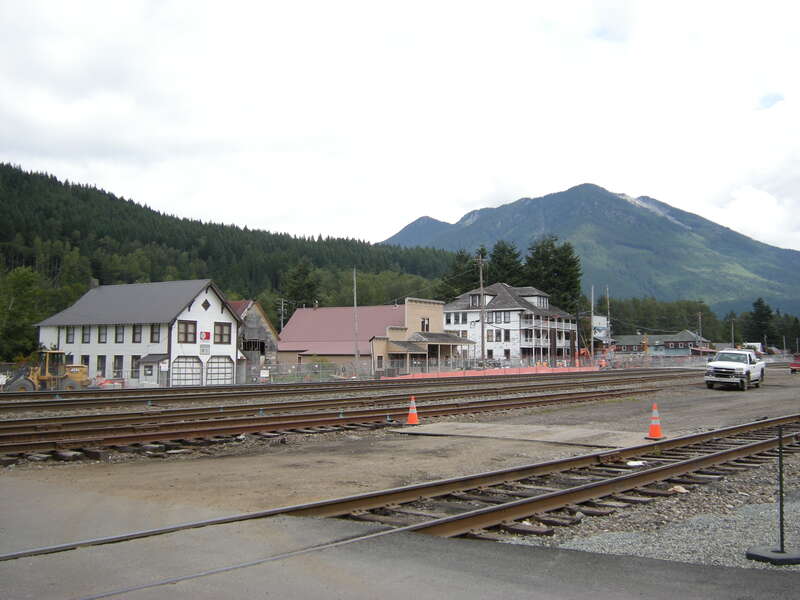 The heart of Skykomish, Washington. The building at left is the Skykomish Historical Society Museum. The large white building at center-right is the Skykomish Hotel. In between is Maloney's General Store, listed on the National Register of Historic