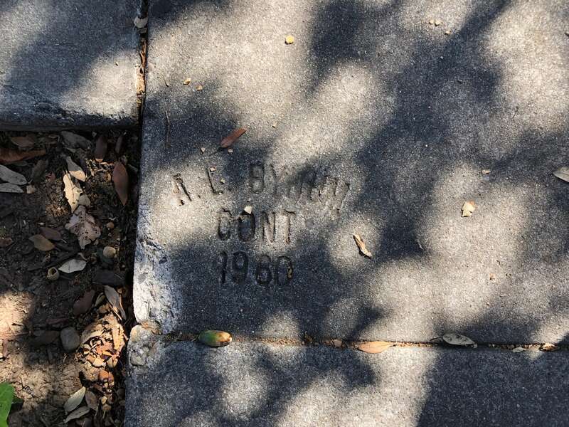 Sidewalk stamp by A. L. Bynum Contractor in 1980 on North 2nd Street in San Jose, California, United States.