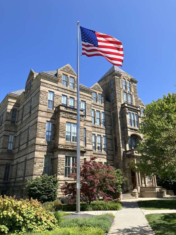 Adelbert Hall on the campus of Case Western Reserve University in Cleveland, Ohio, United States, seen with an American flag