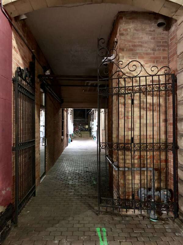 A gated passage under a building in downtown Bowling Green, Ohio.
