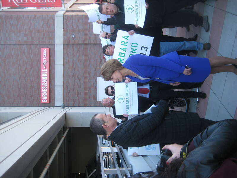 Barbara Buono in news interview, with her supporters behind her, in New Brunswick, NJ
