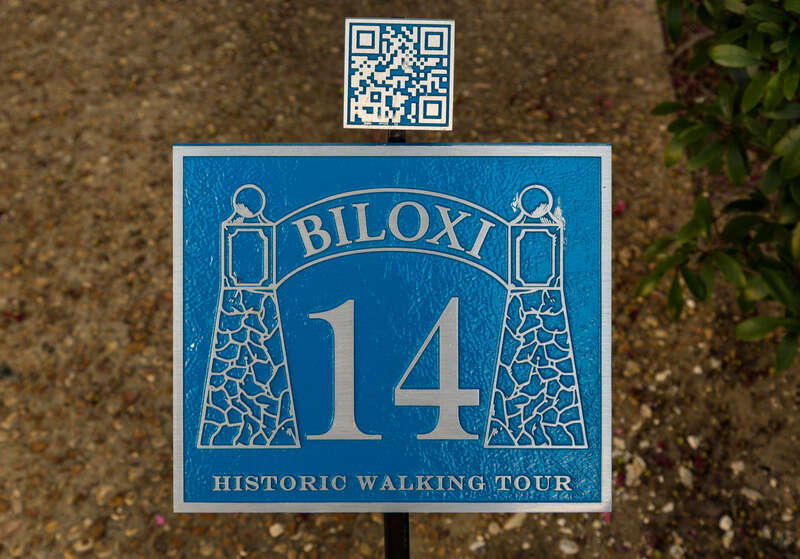 A sign with a QR code near Howard Avenue &amp;amp; Rue Magnolia for a historic walking tour, in Biloxi, Mississippi.