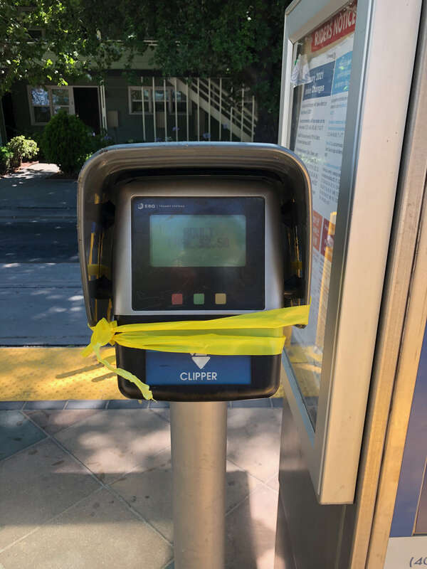 A Clipper card validation machine wrapped in yellow caution tape at the Japantown/Ayer station in San Jose, California, in June 2021. The entire VTA light rail system was suspended indefinitely following a mass shooting at the VTA light rail yard in