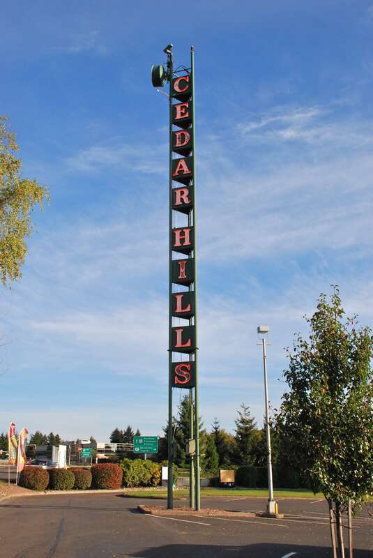 The tall, neon &quot;Cedar Hills&quot; sign, a local landmark – in place since the 1950s and visible from the nearby Sunset Highway (freeway). It is located in the parking lot of the Cedar Hills Shopping Center, which opened in 1955 and is located immediately