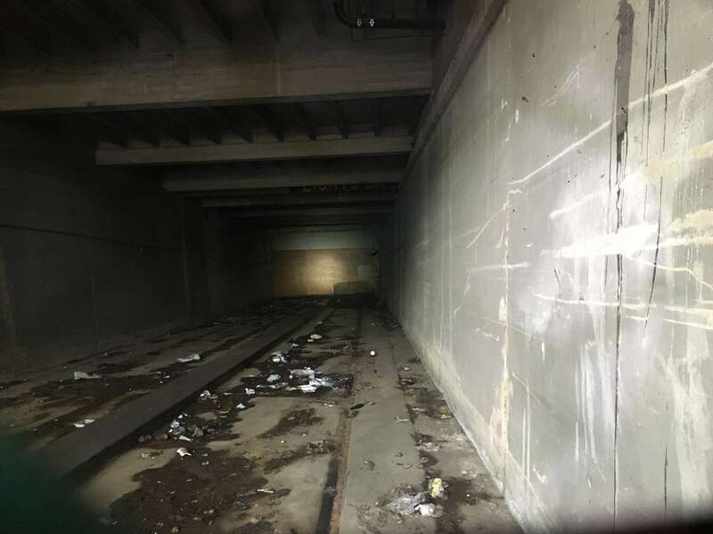 The Cedar street subway portal where it intersects Washington street in downtown Newark. This is a view of the interior showing the intact tracks and in the distance a plywood wall blocking it off.