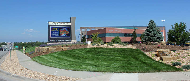 The Centennial Civic Center (City Hall), located at 13133 East Arapahoe Road in Centennial Colorado. The picture shows Arapahoe Road, looking west, the city's electronic sign, and the main civic center building, which is at a lower elevation behind