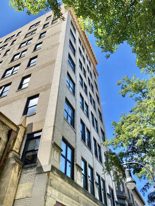 Built in 1914-1915, this Classical Revival-style skyscraper was designed by James R. Law and was originally known as the Gay Building.  The building is clad in cream-colored brick with limestone trim, limestone pilasters and a limestone architrave