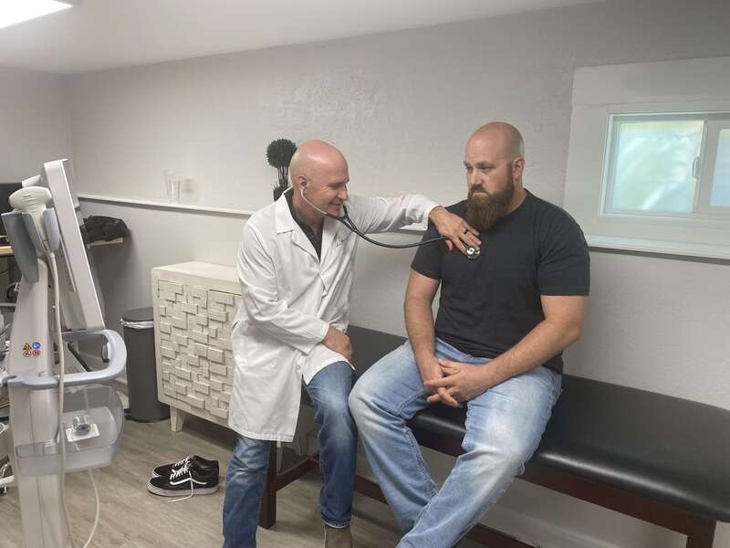 Dr. Lee Moorer At Castle Rock Mens Health with a person for Check Up