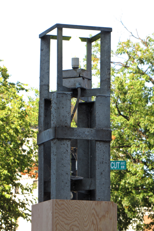 Pylon marking the south entrance of Dupont Circle station, stripped of its brown metal skin, leaving only the frame and the light bulb behind.  The frame was partially encased in plywood until the metal skin was reinstalled.

Ben Schumin is a