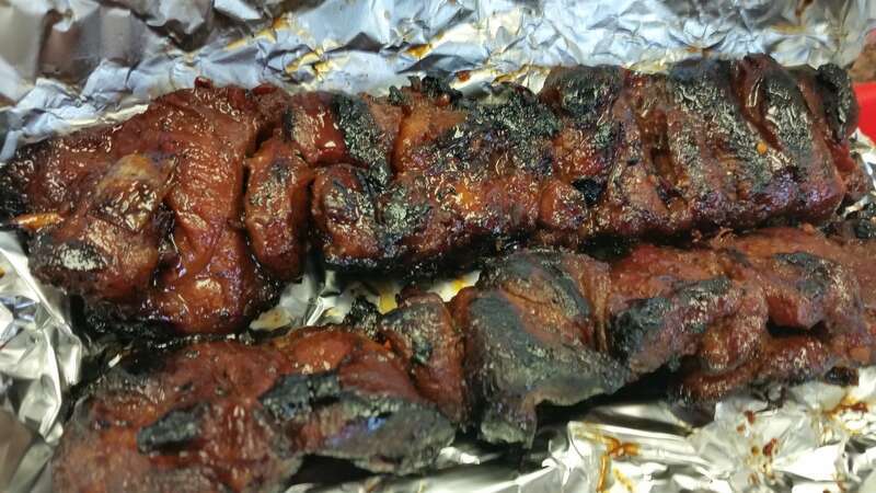 Two sticks of Filipino pork barbecue served at Jochi Resto Grill in Chula Vista