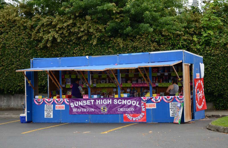 A small fireworks stand in Cedar Mill, Oregon, with proceeds going to support the marching band and color guard of nearby Sunset High School (of the Beaverton School District). This stand was located in the parking lot of the Bales Thriftway store,