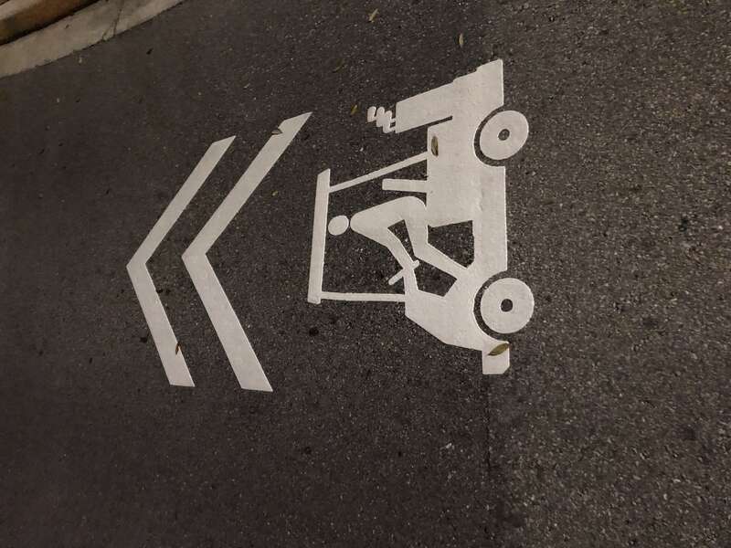 Sharrows on Annunciation Circle in Ave Maria, FL that depict a golf cart instead of a bicycle.