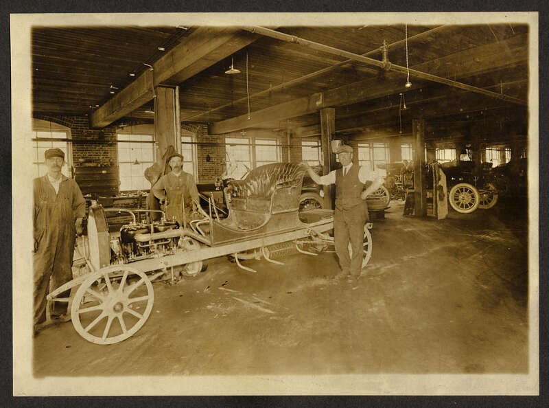 I believe the car in the foreground is a 1910 Moyer body with a 1912 starter attached to the engine. There are several clues about the car and in the rest of the photo that would seem to verify this but I'm not 100% certain. If it is a Moyer, this