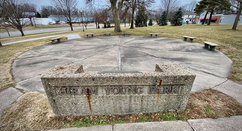 Wagon wheel sculpture, 50 feet wide in-ground, made of concrete and wood, at Hiram Young Park in Independence, Missouri, to honor the contributions by wagon maker Hiram Young to Oregon Trail pioneering
