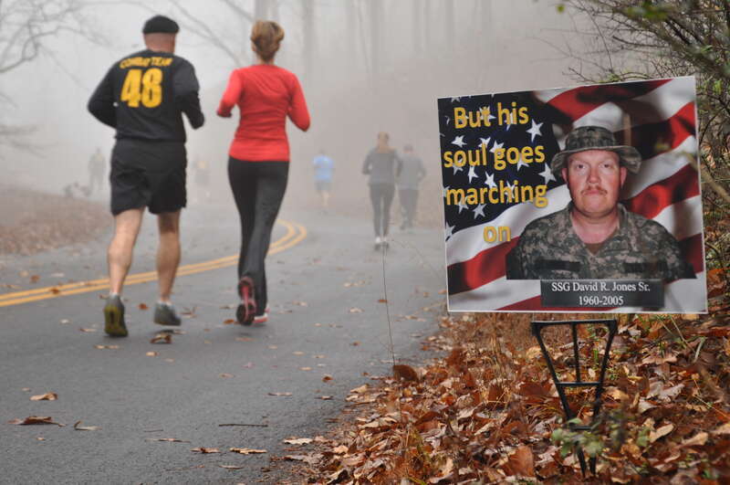 KENNESAW NATIONAL BATTLEFIELD, Kennesaw, Ga, November 23, 2013 – Runners pass a commemorative picture of Staff Sgt. David R. Jones Sr., KIA 2005 in Iraq. Georgia Army National Guard photo by Captain William Carraway / Released.
