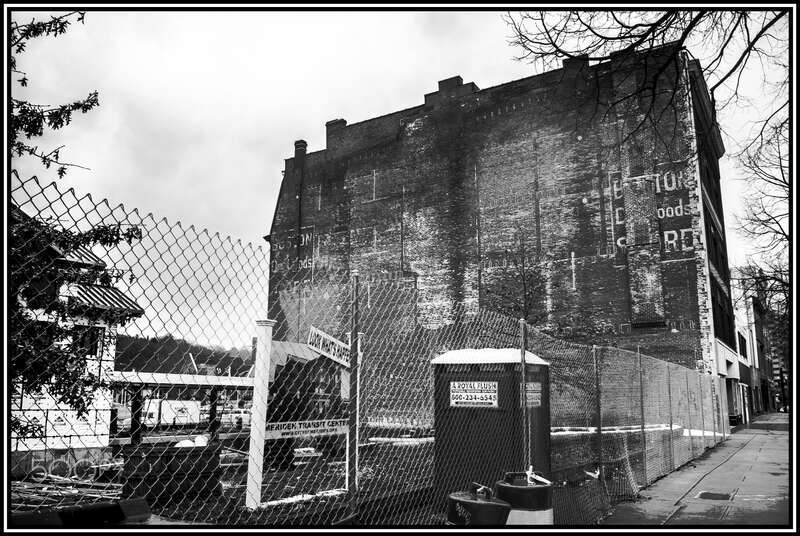 500px provided description: Meriden, CT USA  

The Last standing original building by the railroad tracks where East Main St. becomes West Main St. [#raining ,#Architecture ,#Black and white ,#Building ,#Meriden ,#Downtown ,#Historic ,#Pentax k-x