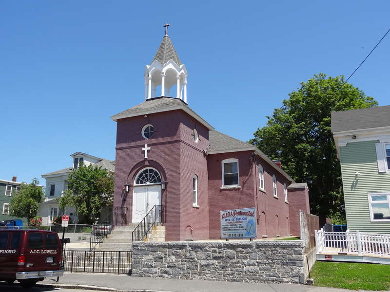 Iglesia Arca de Refugio, a Hispanic Pentecostal church located at 60 Lawrence Street, Lowell, Massachusetts.  West (front) and south sides of building shown, with a church bus visible at left.