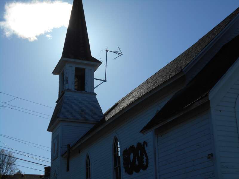 Antenna for Bellingham's new community radio station KVWV stuck out of the old steeple of a church building that used to be called &quot;The Karate Church.&quot;  It was the home of a Karate Institute, but now there are plans to put the Alternative Library