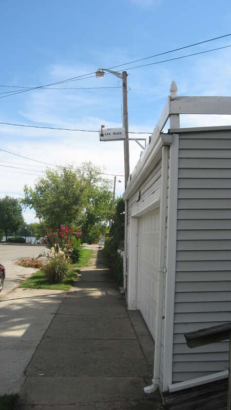 Sidewalk in front of a house on the western side of the 100 block of Pearl Street in Jeffersonville, Indiana, United States.  Note the &quot;air mail&quot; letterbox above the garage door.