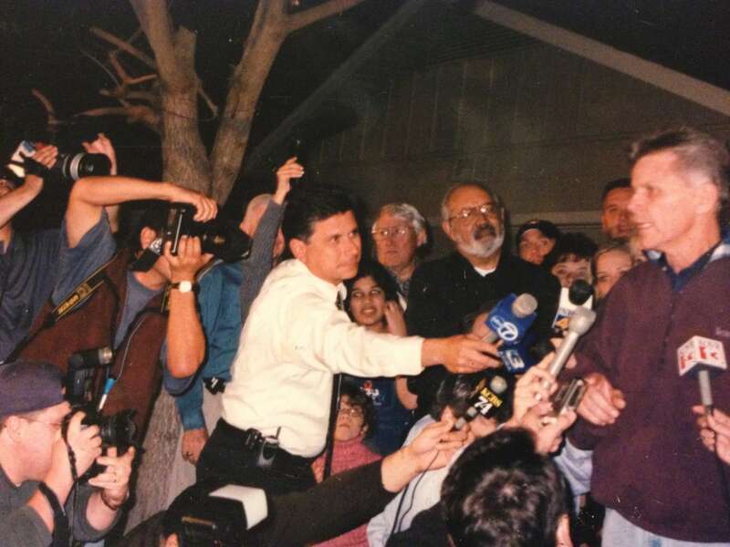 Jim Wieder (in white shirt) reporting on the resignation of congressman Gary Condit (right) during Chandra Levy scandal