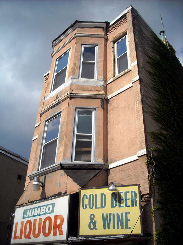 The facade of Jumbo Liquor, located at 1122 H Street, N.E., in the Near Northeast neighborhood of Washington, D.C.
Built in 1895, the brick, three-story, Queen Anne liquor store originally served as the office and residence of Peter Daly, a licensed