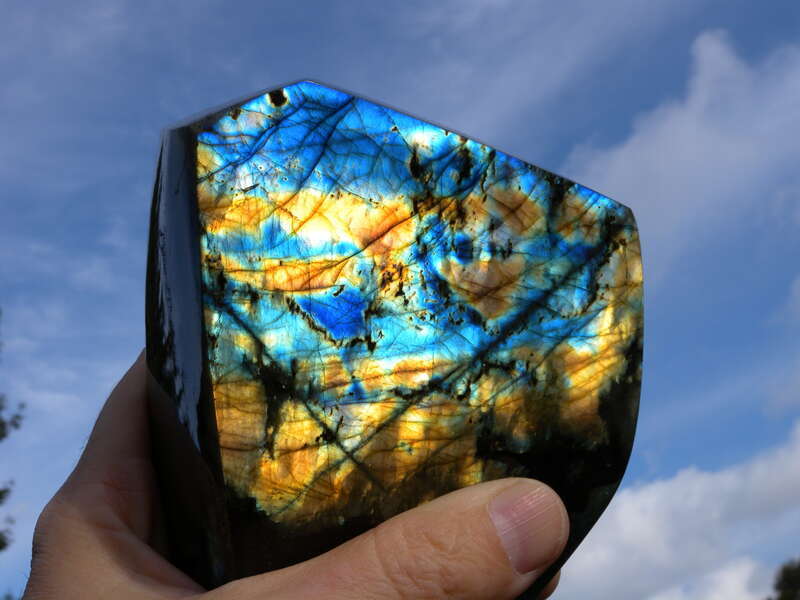A feldspar mineral. The colors are called "labradorescence" or the "schiller effect."