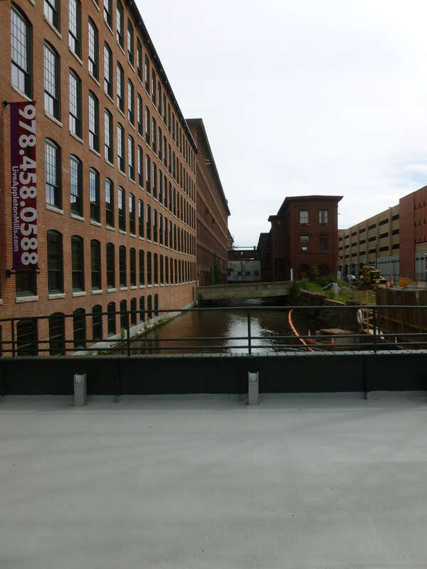 Looking east along the canal between Appleton and Hamilton Mills.  Photograph taken from the foot bridge at the main gate of Appleton Mills Apartments, located at 219 Jackson Street, Lowell, Massachusetts.