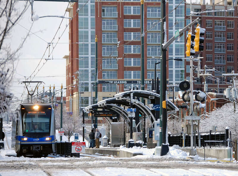 A Lynx Blue Line light-rail train arriving at the East/West Boulevard station, in Charlotte, North Carolina, a snowy day.