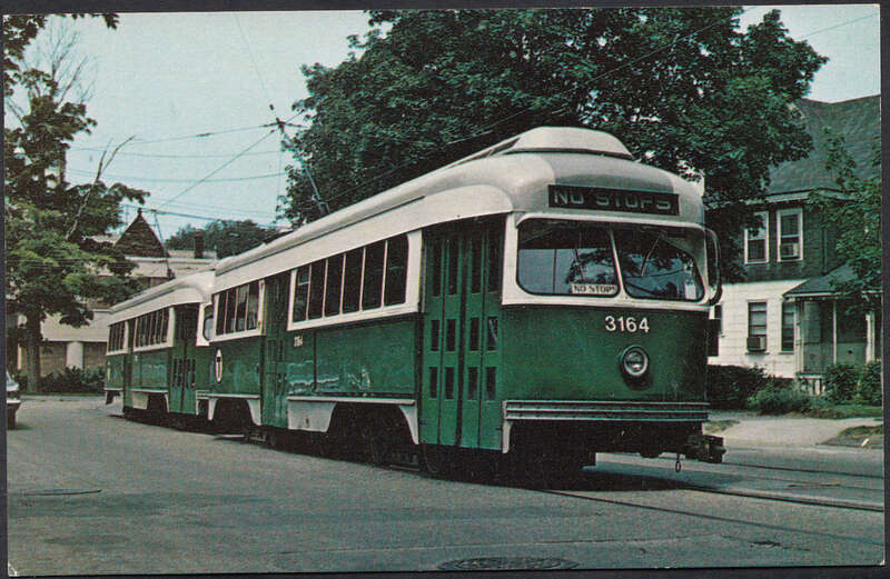 Postcard of two MBTA PCC streetcars returning from the paint shops at Watertown in 1972, three years after the line closed to passenger service. They are photographed here at the intersection of Park and Tremont streets near Newton Corner.