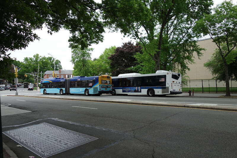 A northbound Q44 SBS bus (left) and a out-of-service Q20A bus in front of John Bowne High School at Main Street and Reeves Avenue in Queensboro Hill / Kew Gardens Hills, Flushing, Queens. Both these buses are &quot;school tripper&quot; buses serving the high