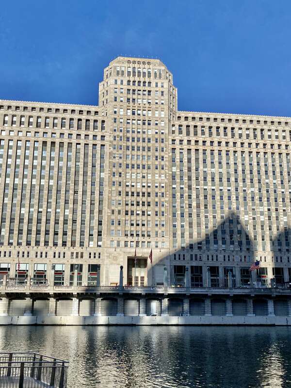 Built in 1928-1930, this Art Deco-style building was designed by Graham, Anderson, Probst and White for Marshall Field and Company, and is known as Merchandise Mart, housing multiple retail and wholesale operations on the former site of a train yard,