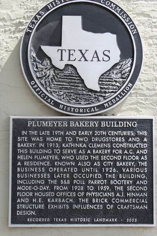 Plumeyer Bakery Building. In the late 19th and early 20th centuries, this site was home to two drugstores and a bakery. In 1913, Kathinka Clemens constructed this building to serve as a bakery for A.C. and Helen Plumeyer, who used the second floor as
