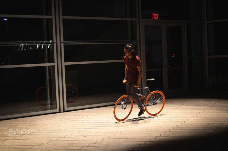500px provided description: Night riding at Walt Disney concert hall [#night ,#outdoor ,#dark ,#male ,#teenager ,#sports ,#cycling ,#fixie ,#skid ,#fixed gear ,#skiding]