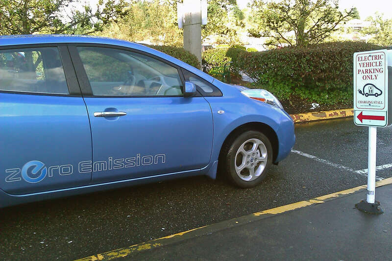 Nissan Leaf at a parking space reserved for electric vehicles
