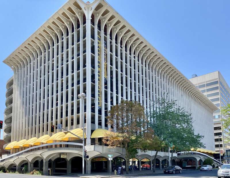 Built in 1967, this Brutalist building was designed by Warren C. Heylman to serve as a parking garage, known as Parkade Plaza.  The building features a concrete structure, exterior fins with flared brackets at the cornice, vaulted ceilings below the