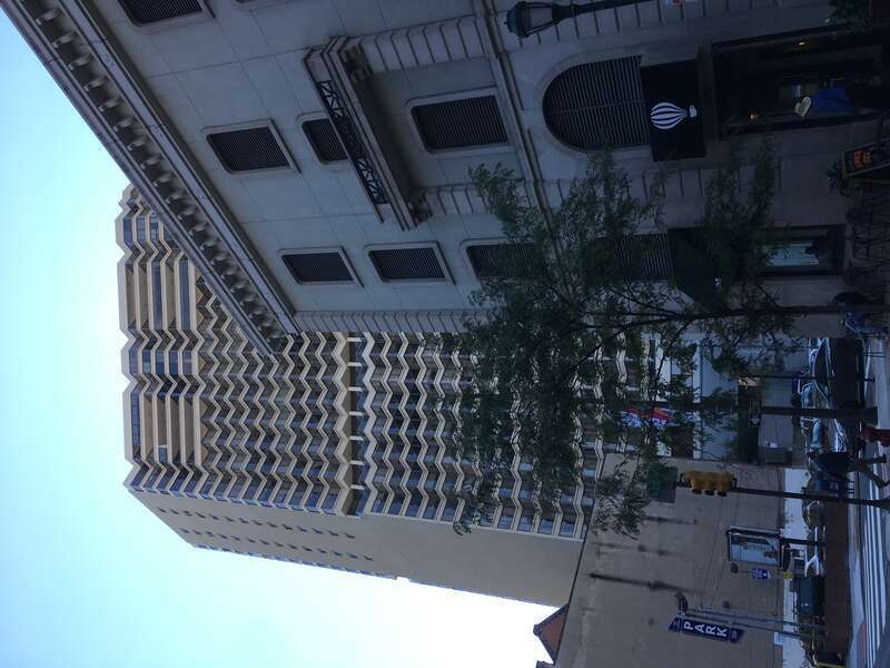 Contrasting architectures: a modern office tower and historic building overlap near Rittenhouse Square, Philadelphia