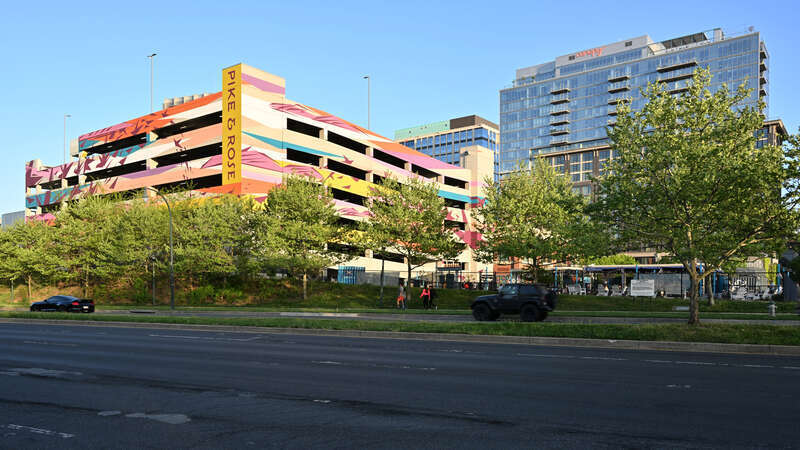 Pike and Rose as seen from Josiah Henson Parkway in North Bethesda, Maryland. There is a large parking garage with a mural on it.