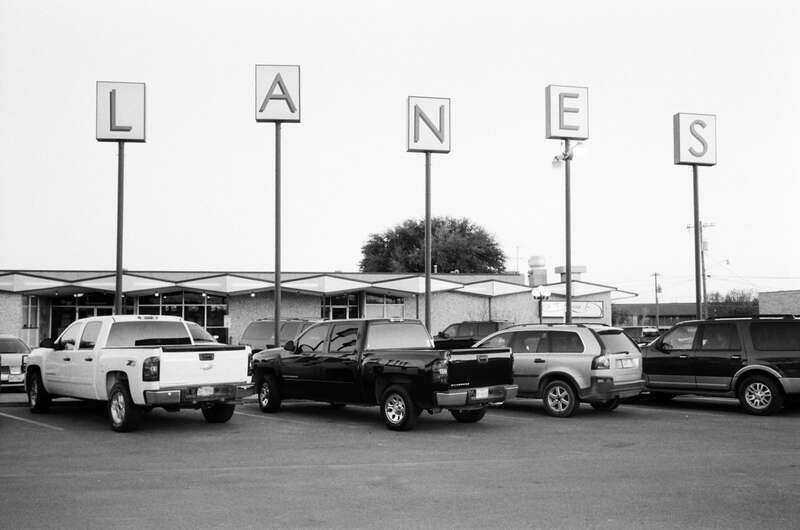 500px provided description: San Angelo [#cars ,#black and white ,#sign ,#texas ,#bowling ,#parking lot ,#west texas ,#san angelo]