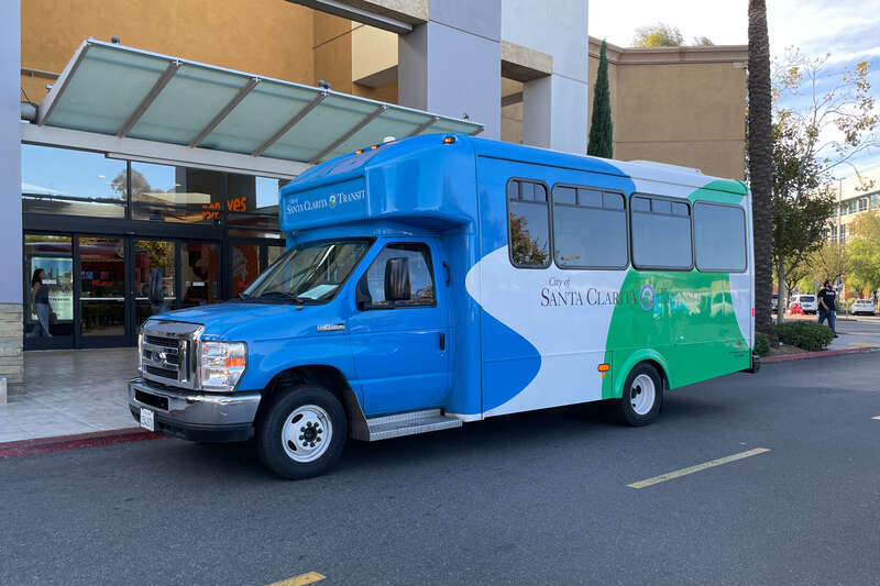 A Santa Clarita Transit Dial-a-Ride bus picking up passengers at the food court of Westfield Town Centre.