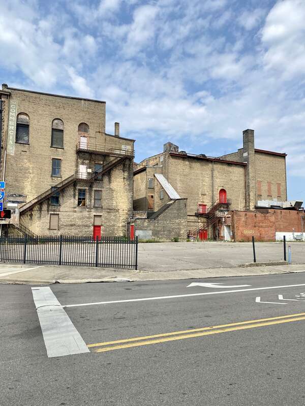Built in 1890, this Richardsonian Romanesque Revival-style building was designed by Samuel Hannaford for Paul J. Sorg to serve as an opera house.  The building features a brick exterior with a rough-hewn stone front facade, arched window bays on the
