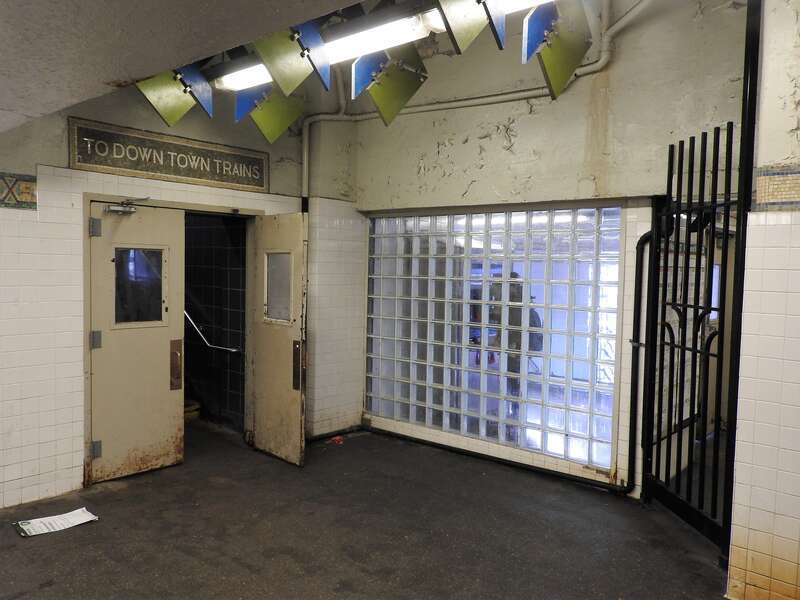 Looking northwest at door and glass wall on a sunny afternoon