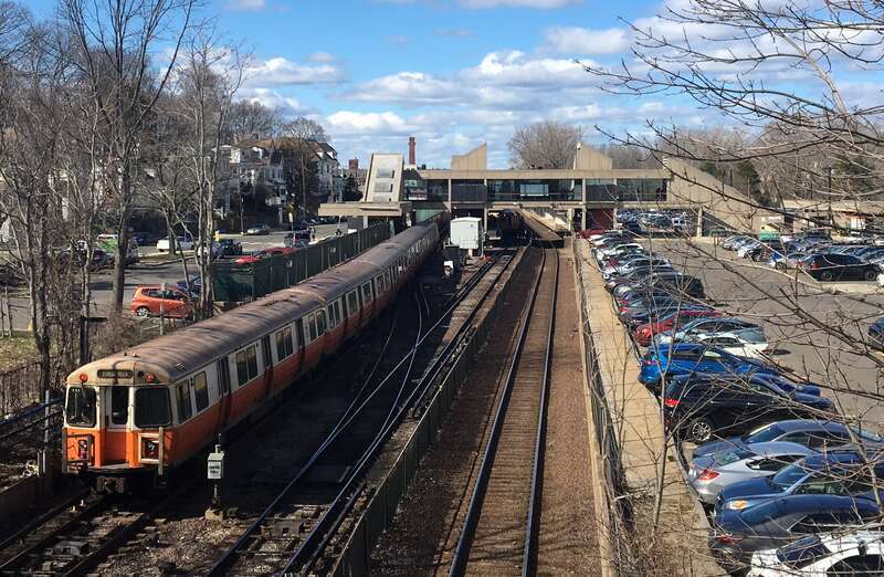 A southbound Orange Line train leaving Oak Grove station in April 2018