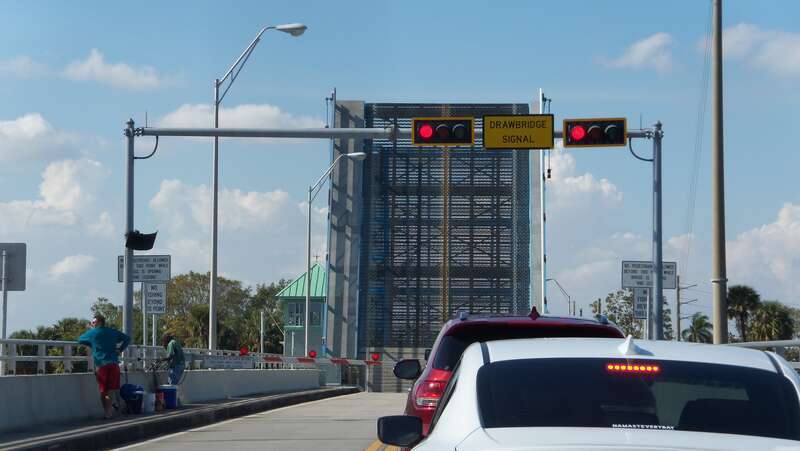 Roadway view of the St. Lucie River Bridge, in Stuart, Florida, with traffic waiting during an opening of the drawbridge span. Built in 1964, the double-leaf bascule bridge carries the Dixie Highway (FL 707) across the St. Lucie River.