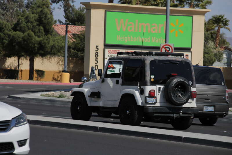 A white Jeep Wrangler TJ driving in the northbound lanes of North Jones Boulevard, Las Vegas, Nevada.