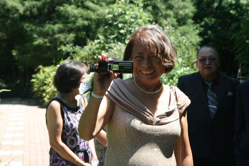A wedding guest using a digital camcorder at a wedding held at the J. C. Raulston Arboretum in Raleigh, North Carolina.