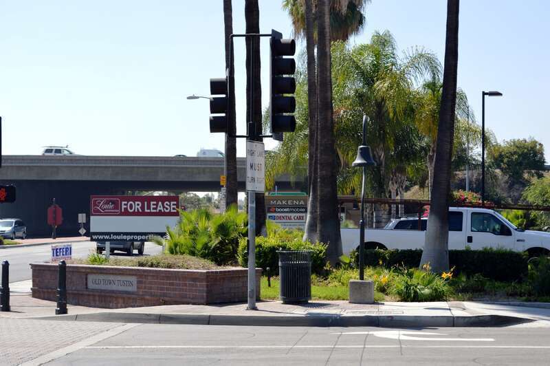 One of several El Camino Real bells along El Camino Real in Old Town Tustin. This one is on the west corner of El Camino Real and Newport Avenue, with Interstate 5 in the background.